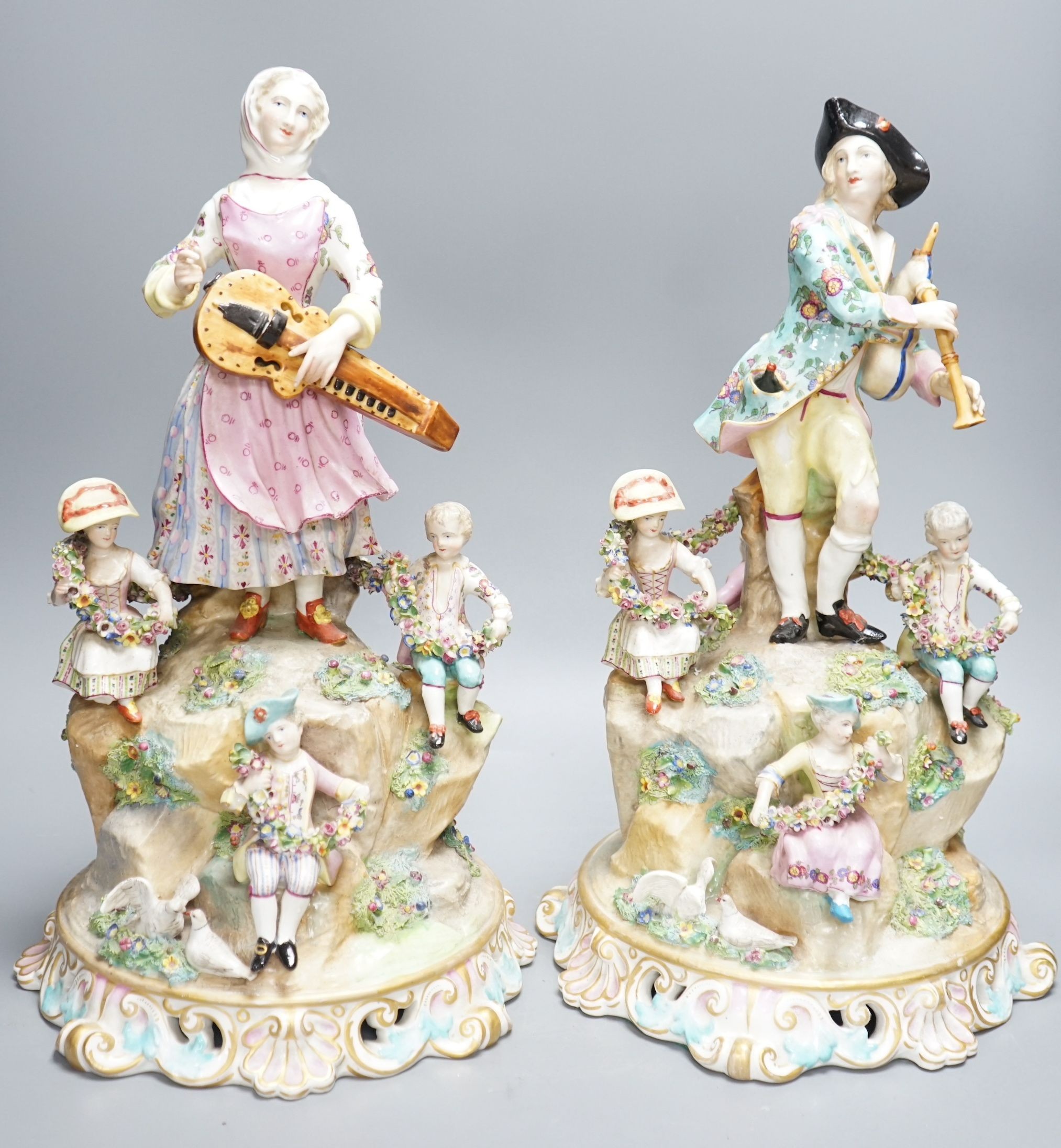 A pair of Meissen style porcelain musician figure groups, 42cms high